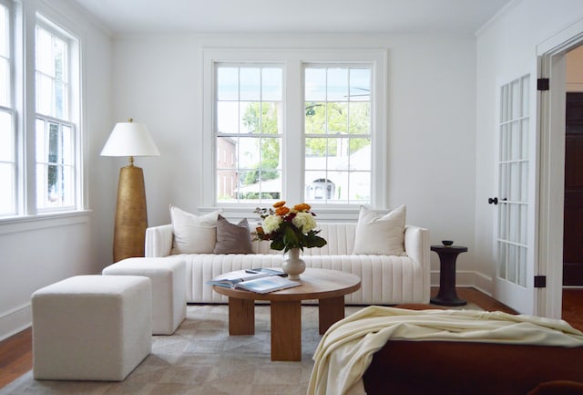 sitting room with crown molding, baseboards, and light wood finished floors