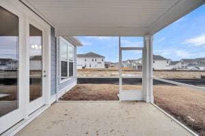 unfurnished sunroom featuring a residential view