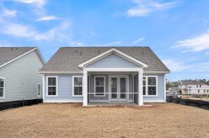 rear view of property featuring fence