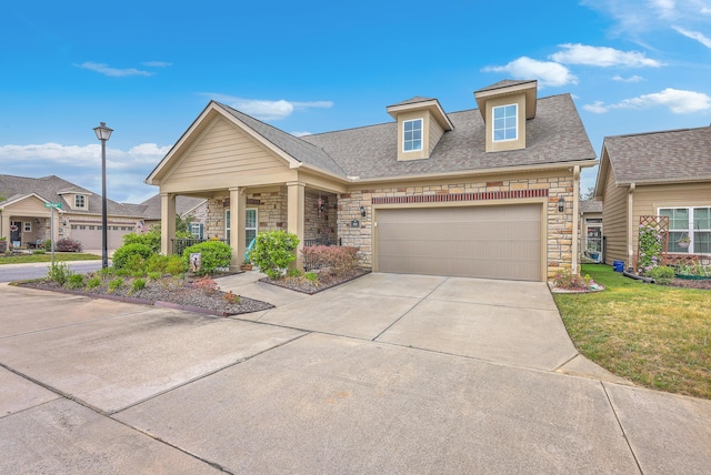 craftsman-style house with an attached garage, driveway, stone siding, roof with shingles, and a front yard