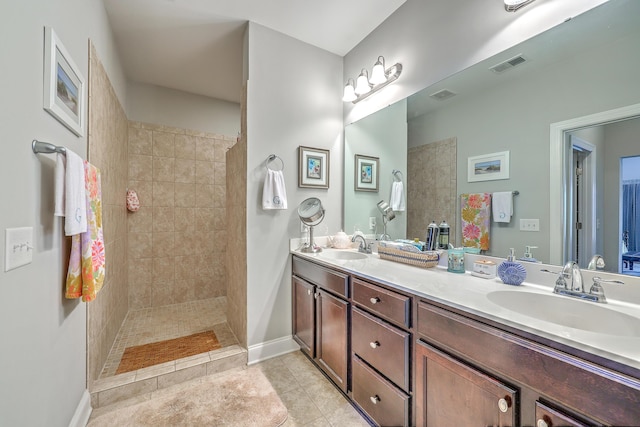 bathroom with walk in shower, a sink, and visible vents