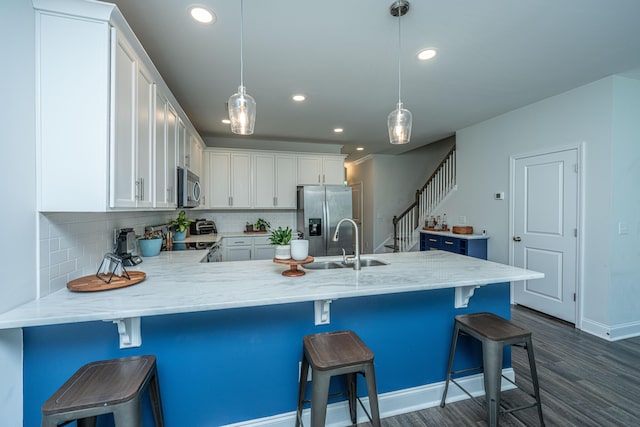 618 Ravensridge Ln, Moncks Corner, SC 29461 - kitchen featuring stainless steel appliances, a sink, dark wood-style flooring, a peninsula, and white cabinets