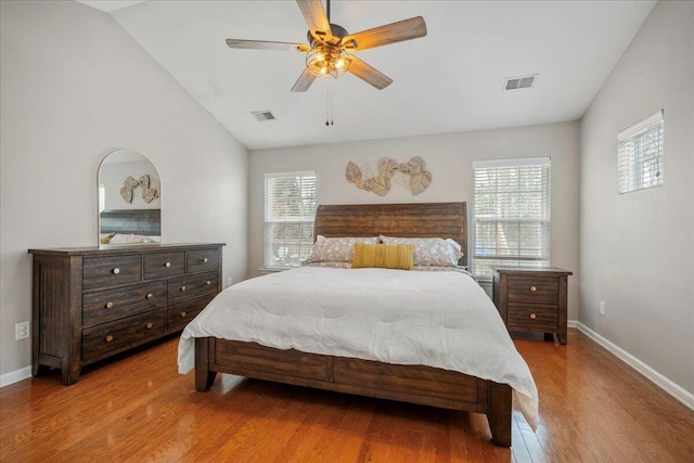 bedroom featuring ceiling fan, lofted ceiling, and light hardwood / wood-style flooring