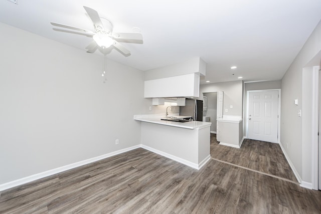 142 Marsh View Villas, Folly Beach, SC 29439 - kitchen featuring light countertops, white cabinets, dark wood finished floors, a ceiling fan, and a peninsula