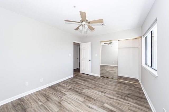 142 Marsh View Villas, Folly Beach, SC 29439 - unfurnished bedroom featuring wood finished floors, baseboards, a closet, and a ceiling fan