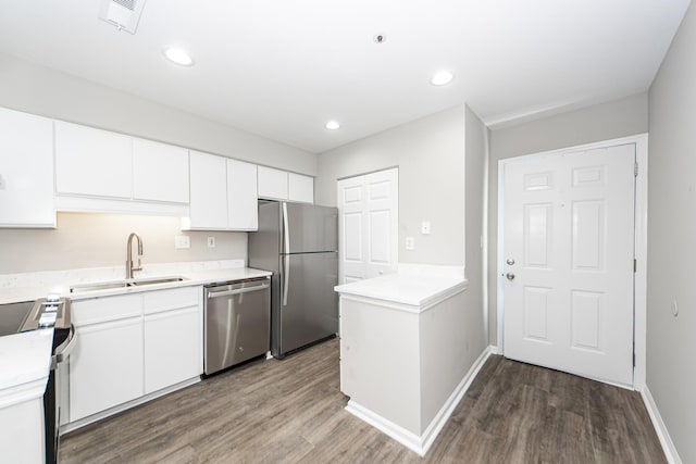142 Marsh View Villas, Folly Beach, SC 29439 - kitchen featuring stainless steel appliances, a sink, wood finished floors, baseboards, and recessed lighting