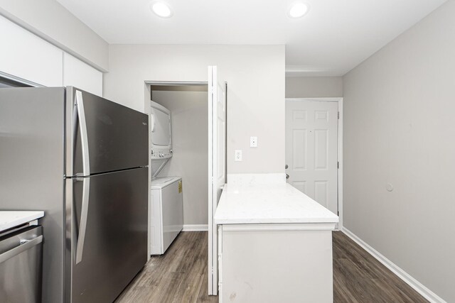 142 Marsh View Villas, Folly Beach, SC 29439 - kitchen with stacked washer and clothes dryer, stainless steel appliances, white cabinetry, dark wood-style flooring, and recessed lighting