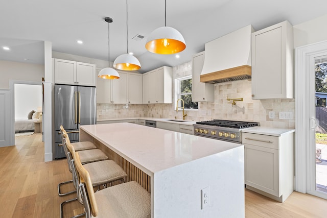 kitchen featuring white cabinets, a center island, plenty of natural light, and custom exhaust hood