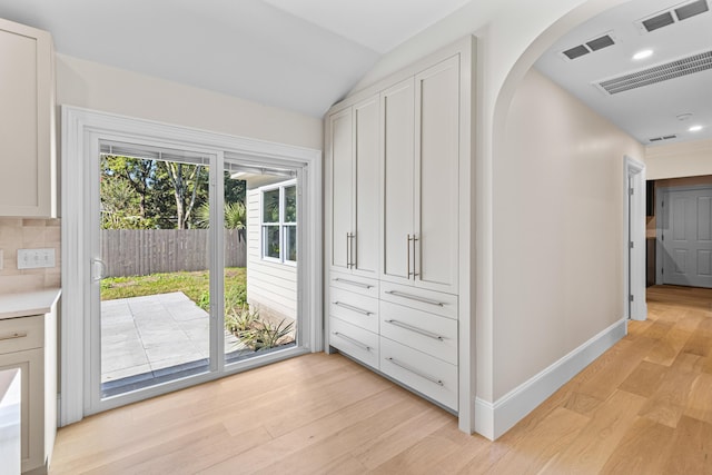 interior space featuring light hardwood / wood-style floors and lofted ceiling