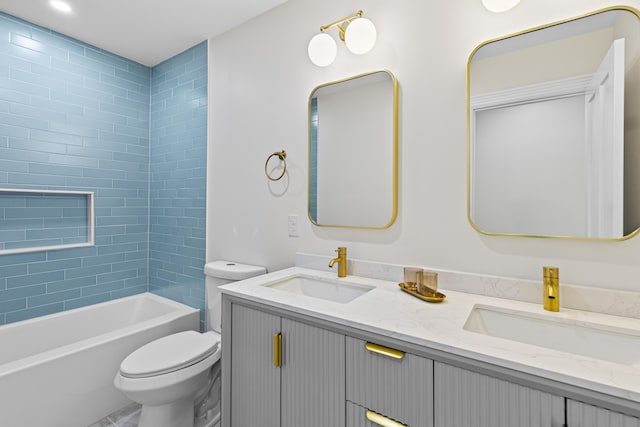 full bathroom featuring vanity, toilet, and tiled shower / bath combo