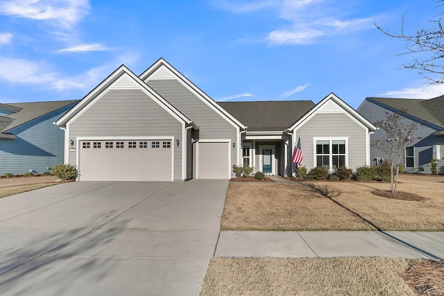 view of front of home featuring a front yard and a garage