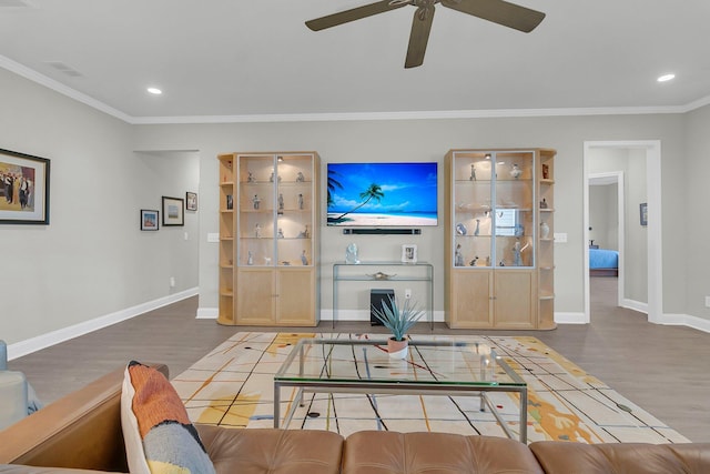 living room featuring ceiling fan, wood-type flooring, and ornamental molding