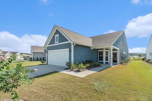 exterior space with a lawn, concrete driveway, roof with shingles, an attached garage, and board and batten siding