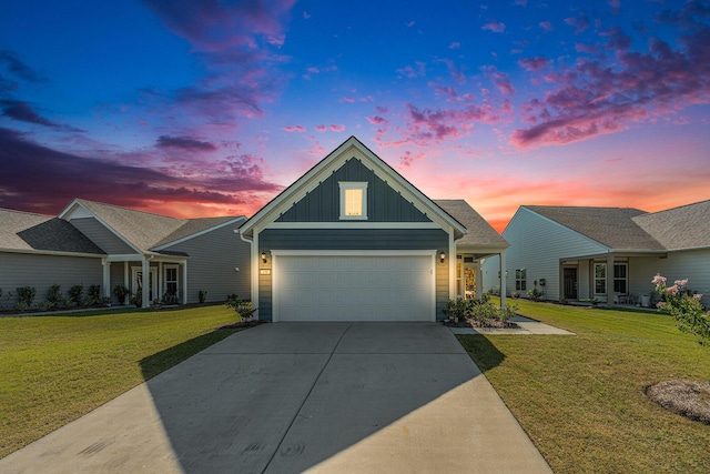 view of front of property with driveway, a front lawn, board and batten siding, and an attached garage