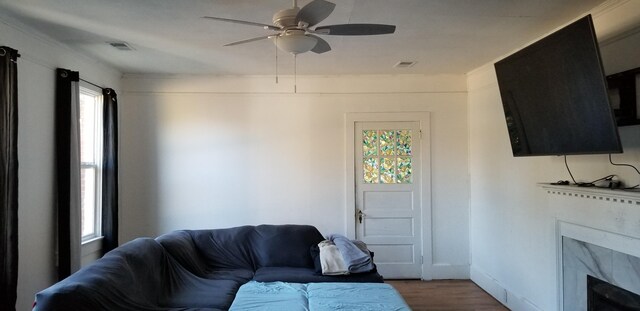 living room with a fireplace, hardwood / wood-style flooring, and ceiling fan