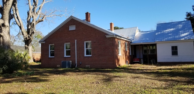 back of property with a lawn