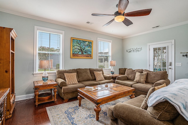 living room with dark hardwood / wood-style flooring, ceiling fan, and crown molding