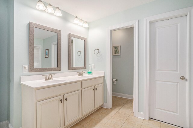 bathroom featuring tile patterned flooring and vanity