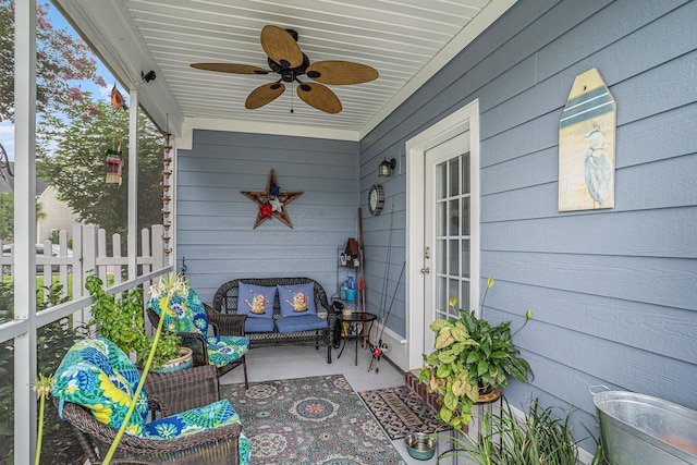 sunroom / solarium featuring ceiling fan