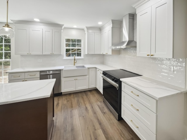 702 Spark St, Mount Pleasant, SC 29464 - kitchen with wall chimney range hood, electric range oven, dishwasher, wood finished floors, and light stone counters