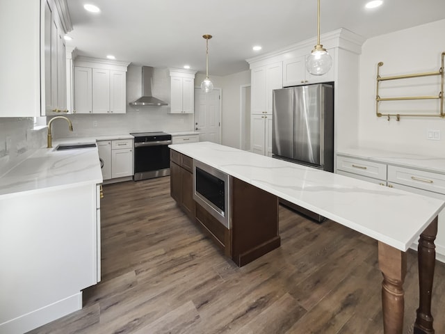 702 Spark St, Mount Pleasant, SC 29464 - kitchen featuring stainless steel appliances, wall chimney range hood, a kitchen island, recessed lighting, and dark wood finished floors