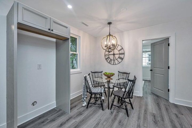 dining room with a notable chandelier and light hardwood / wood-style floors