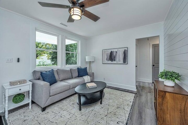 living room with crown molding, hardwood / wood-style floors, and ceiling fan