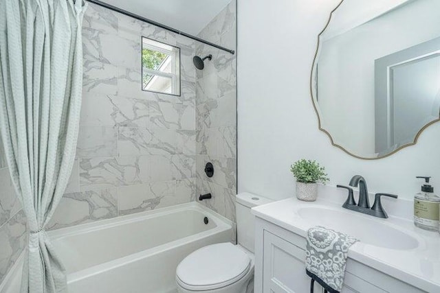 full bathroom featuring shower / tub combo, vanity, and toilet