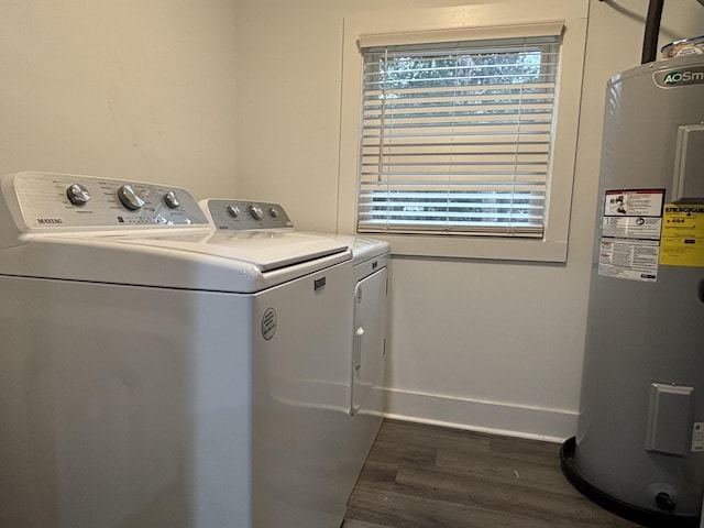 clothes washing area with independent washer and dryer, dark hardwood / wood-style flooring, electric water heater, and a healthy amount of sunlight