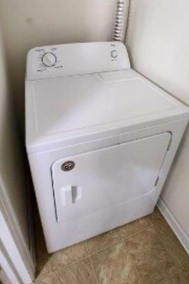 washroom featuring tile patterned flooring and washer / dryer