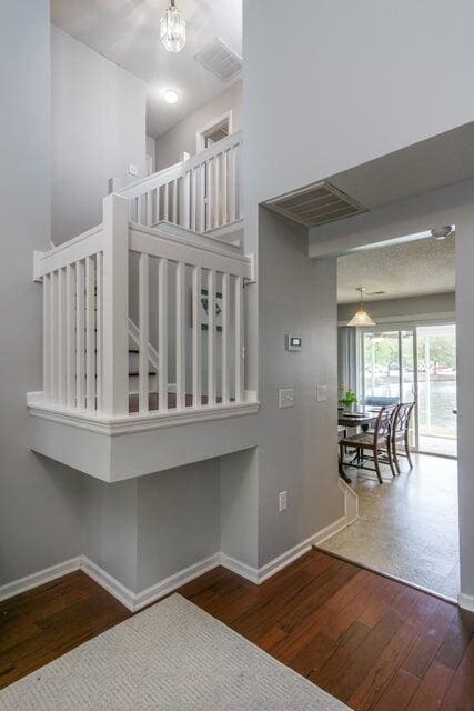 stairway featuring a chandelier and hardwood / wood-style flooring