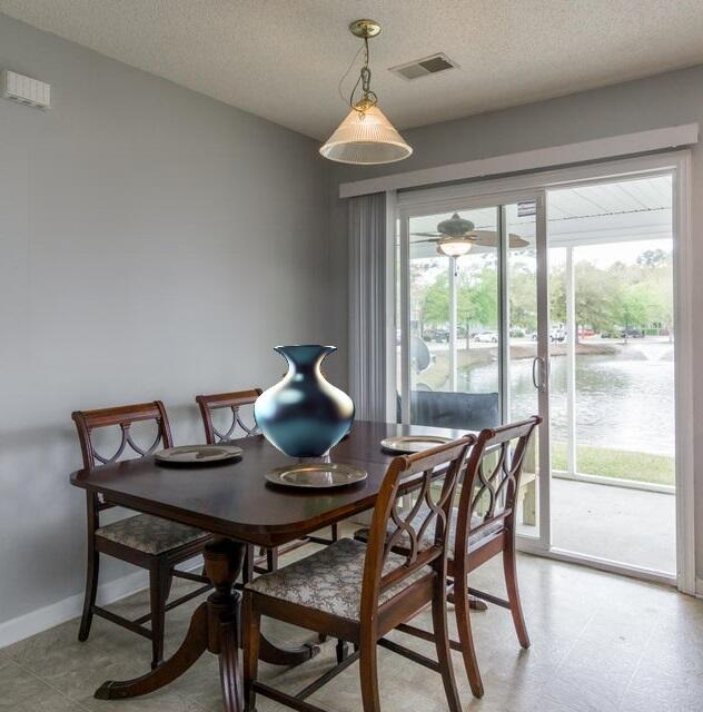 dining room with a textured ceiling and a wealth of natural light