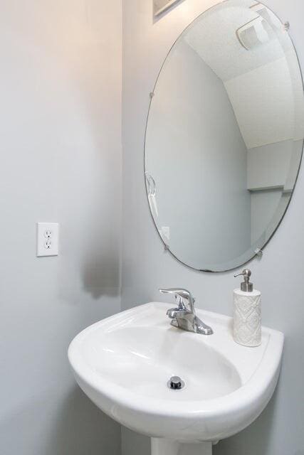 bathroom with sink and vaulted ceiling