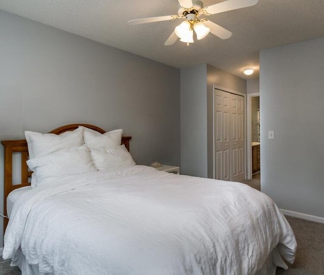 bedroom with ceiling fan, a closet, dark carpet, and a textured ceiling