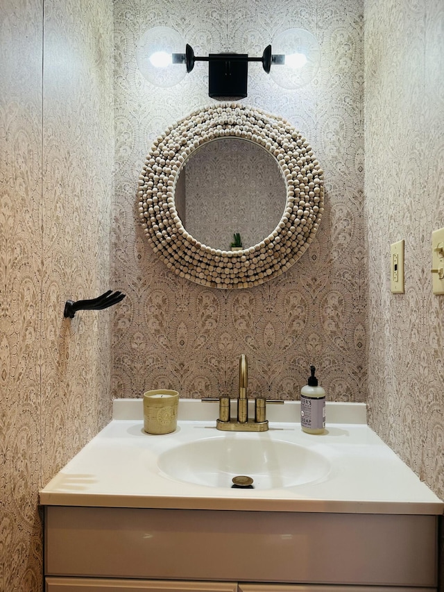 bathroom featuring wallpapered walls and vanity