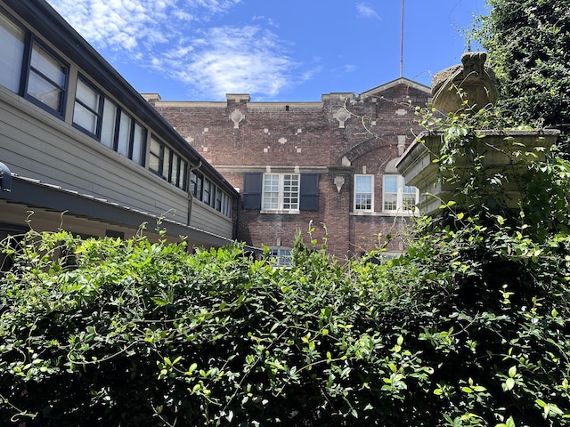 view of side of property with brick siding