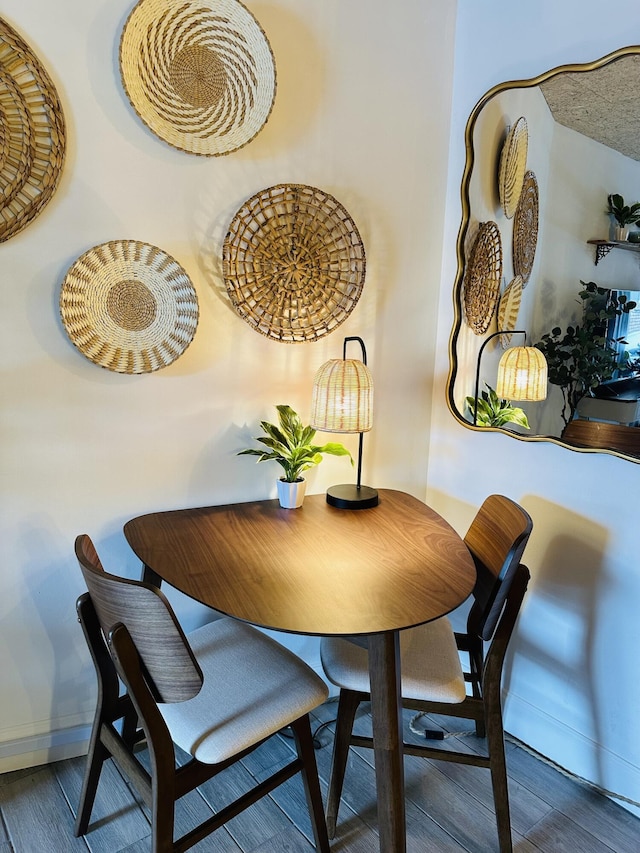 dining area featuring baseboards and wood finished floors