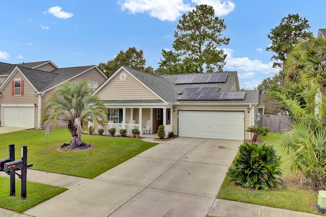 view of front of house with a garage, a front lawn, solar panels, and a porch