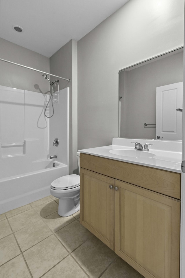 bathroom featuring tile patterned flooring, toilet, vanity, and  shower combination