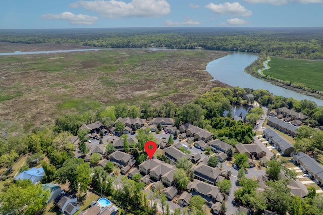 aerial view with a view of trees, a water view, and a residential view