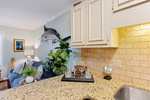 kitchen with hardwood / wood-style flooring, white cabinets, light stone counters, and crown molding