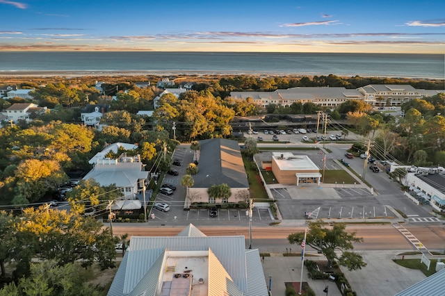 aerial view at dusk featuring a water view