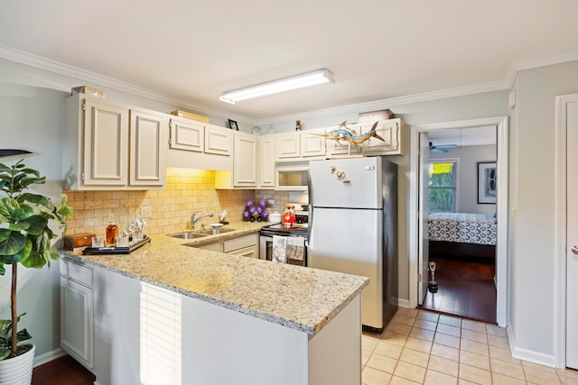 kitchen featuring light stone countertops, sink, appliances with stainless steel finishes, light tile patterned floors, and ornamental molding