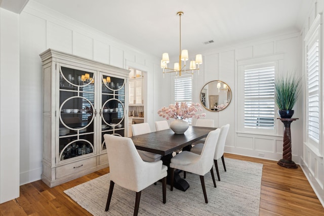 3858 Sawyers Island Dr, Mount Pleasant, SC 29466 - dining space featuring light wood finished floors, visible vents, a decorative wall, and an inviting chandelier