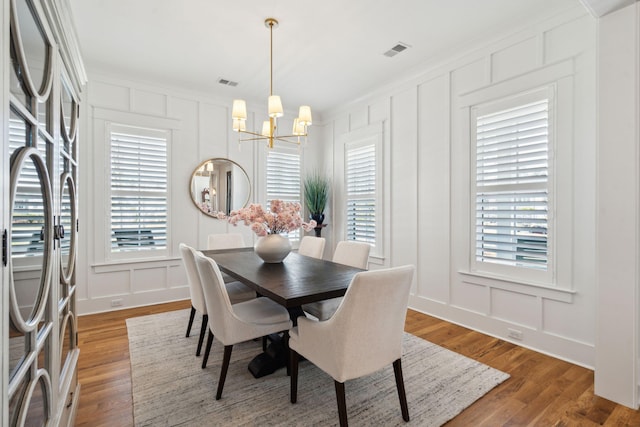3858 Sawyers Island Dr, Mount Pleasant, SC 29466 - dining space featuring a decorative wall, a notable chandelier, wood finished floors, and visible vents