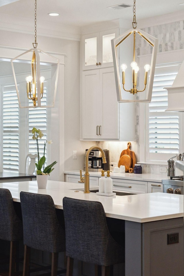 3858 Sawyers Island Dr, Mount Pleasant, SC 29466 - kitchen with light countertops, white cabinetry, hanging light fixtures, visible vents, and an inviting chandelier