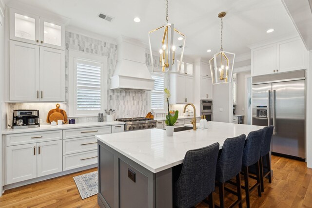 3858 Sawyers Island Dr, Mount Pleasant, SC 29466 - kitchen featuring premium range hood, ornamental molding, a chandelier, a sink, and appliances with stainless steel finishes