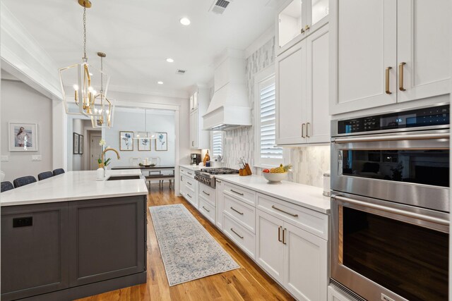3858 Sawyers Island Dr, Mount Pleasant, SC 29466 - kitchen with appliances with stainless steel finishes, premium range hood, visible vents, white cabinets, and an inviting chandelier