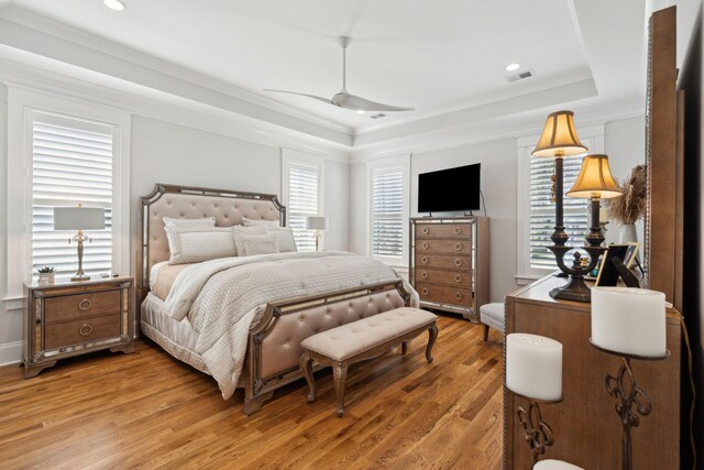 3858 Sawyers Island Dr, Mount Pleasant, SC 29466 - bedroom featuring a tray ceiling, light wood-style flooring, a ceiling fan, and crown molding