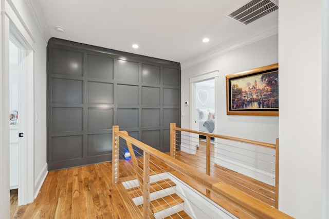 3858 Sawyers Island Dr, Mount Pleasant, SC 29466 - hallway featuring an upstairs landing, crown molding, light wood-style flooring, visible vents, and a decorative wall